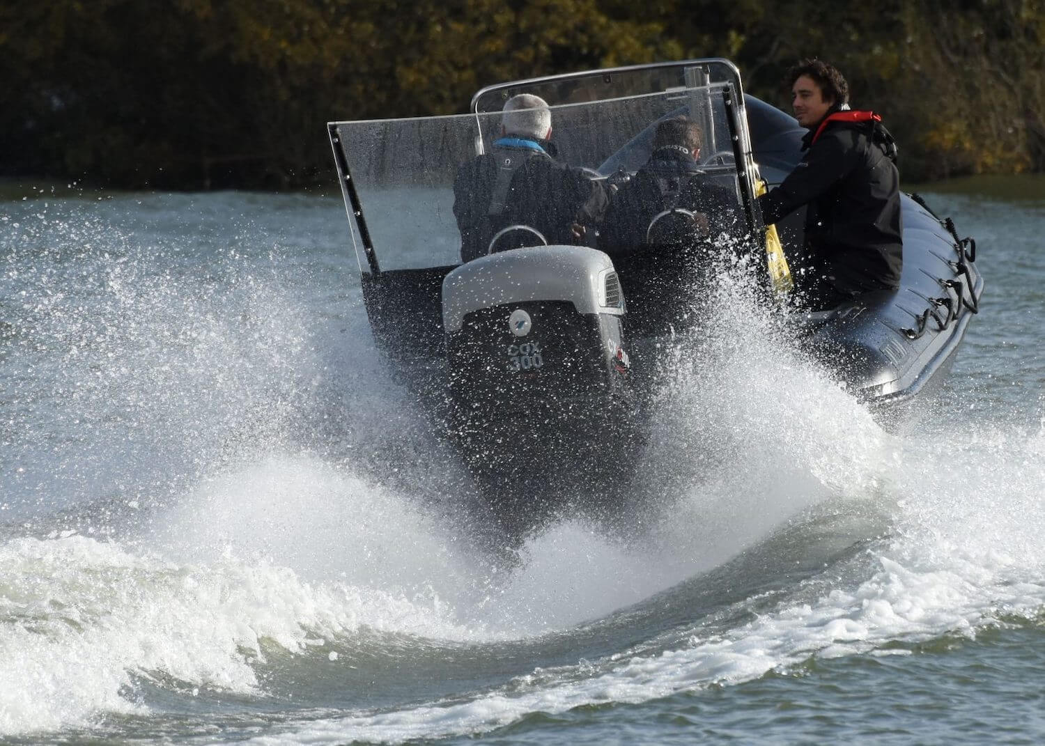 two men on speedboat cox 300