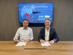 Signing ceremeny for Tractors Machinery International's contract renewal and expansion with Cox Marine, for Southeast Asia and China